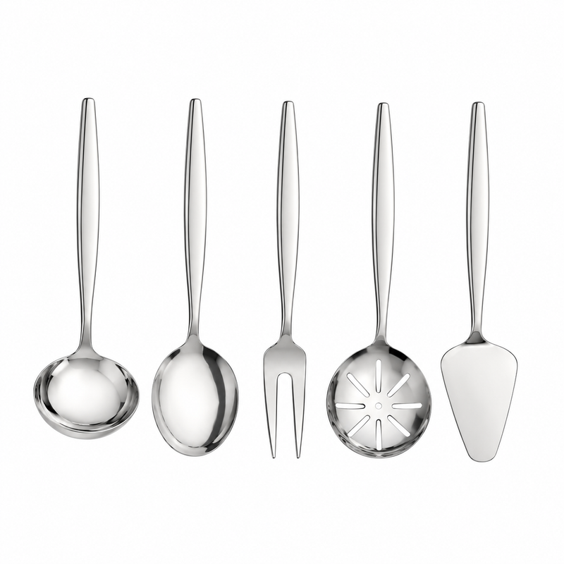 A 5-piece stainless steel serving utensil set arranged on a beige tablecloth with a salad bowl, plates, and dining props around it. The set includes a serving spoon, a serving fork, a decorative serving spoon, a cake server, and a dinner fork.