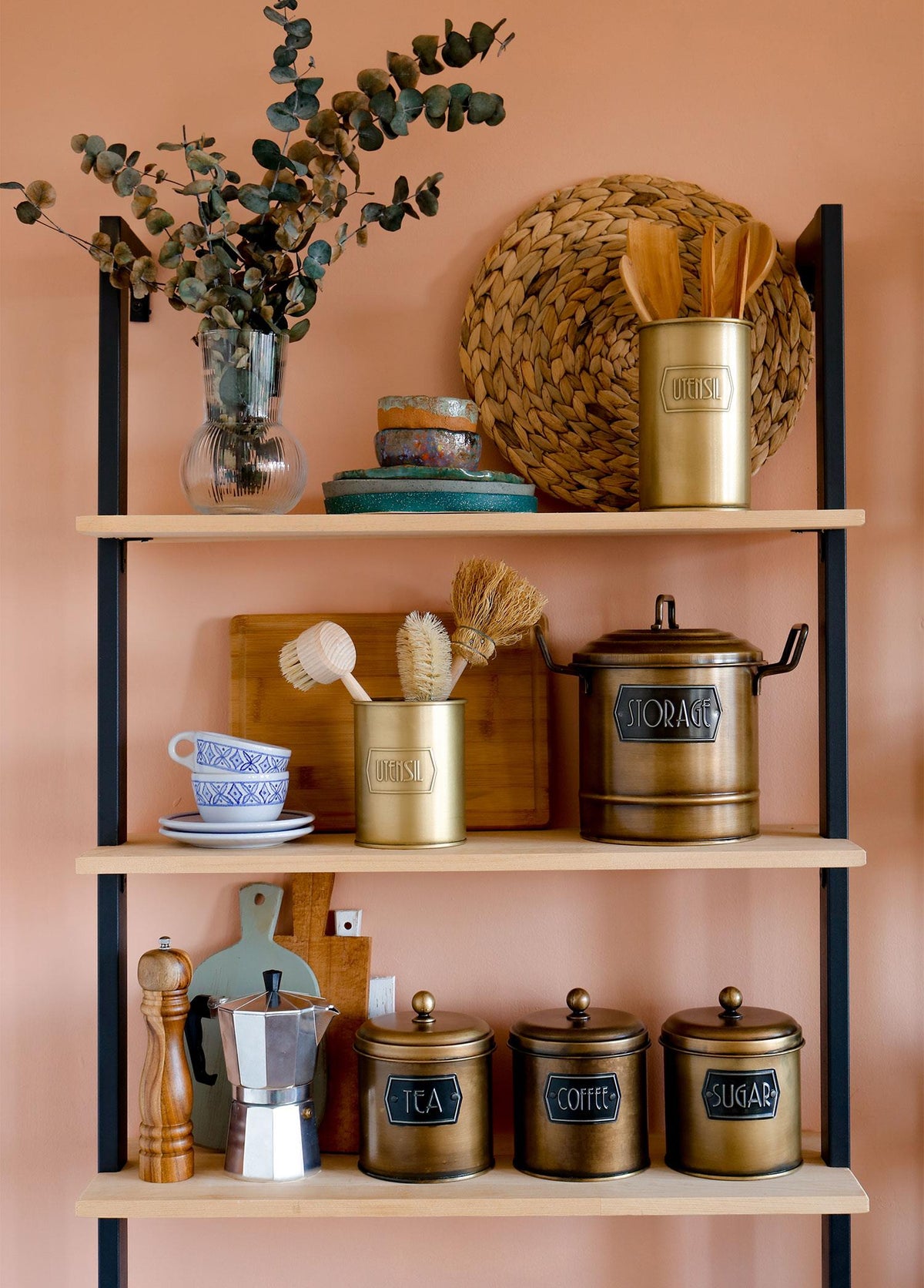 A gold cylindrical utensil holder with the word 'UTENSIL' embossed on the side.